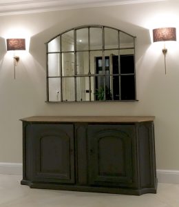 Industrial Slow Arch Architectural Window Mirror displayed over a console cabinet in our clients hallway