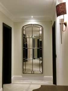 Tall Hand Polished Decorative Window Mirror positioned to open our clients hallway area