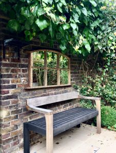 Mirrors displayed over a seating area can work so well