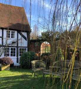 Full Arch mirror installation in this cottage garden space