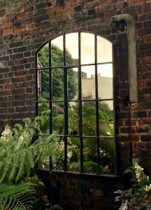 Dark aged patina on this architectural antique mirror