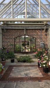 Large Arched Mirror positioned in our clients greenhouse over the fountain/pond space