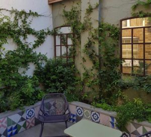 Pairof architectural mirrors in this beautiful Chelsea Courtyard