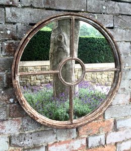 Rustic Round Vintage Mirror wall mounted on an aged brick wall area