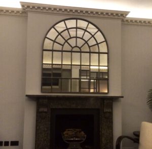 Over Mantle display of this Full Arch Paneled Architectural Window Mirror