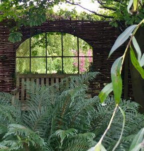 Garden Mirror carefully positioned to reflect our clients Weeping Willow in this darker corner of the garden area